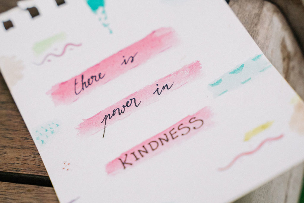 note card reads “there is power in kindness”