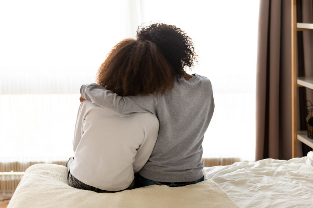 Mother hugs teenage daughter; sexual assault awareness month
