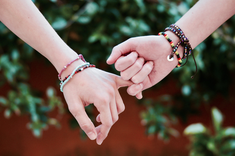 close up of teenagers holding hands showing healthy relationships